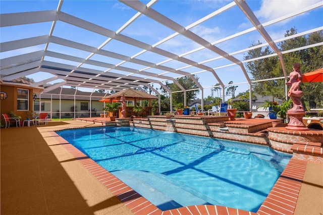 pool featuring a lanai and a patio area