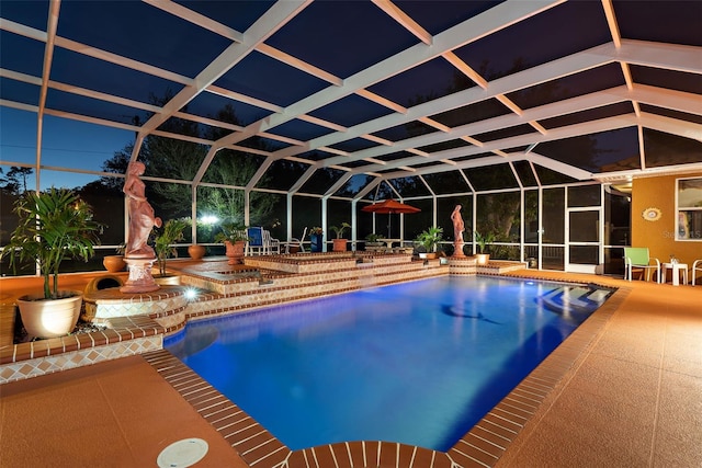 outdoor pool with glass enclosure and a patio