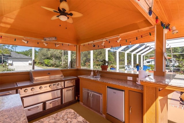 view of patio / terrace featuring a sink, area for grilling, a lanai, and ceiling fan