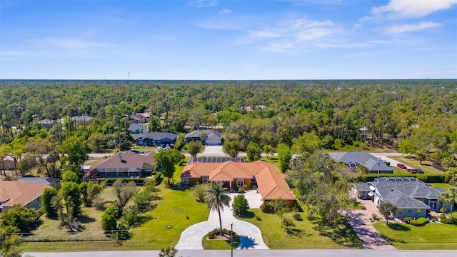 bird's eye view featuring a residential view and a wooded view