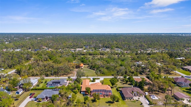 drone / aerial view featuring a residential view and a view of trees