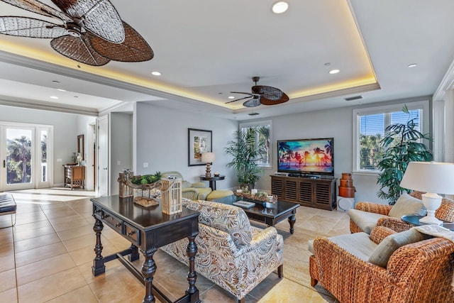 living area with visible vents, a tray ceiling, recessed lighting, light tile patterned floors, and ceiling fan