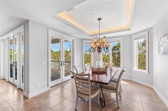 dining room with visible vents, baseboards, light tile patterned flooring, french doors, and a raised ceiling