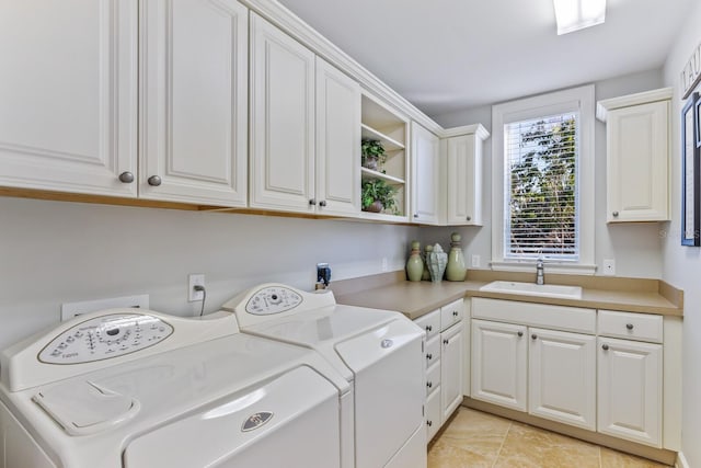 washroom with washing machine and clothes dryer, cabinet space, light tile patterned flooring, and a sink