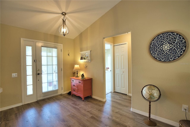 entrance foyer with vaulted ceiling, wood finished floors, and baseboards