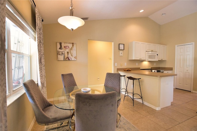 dining space with light tile patterned floors, baseboards, visible vents, high vaulted ceiling, and recessed lighting