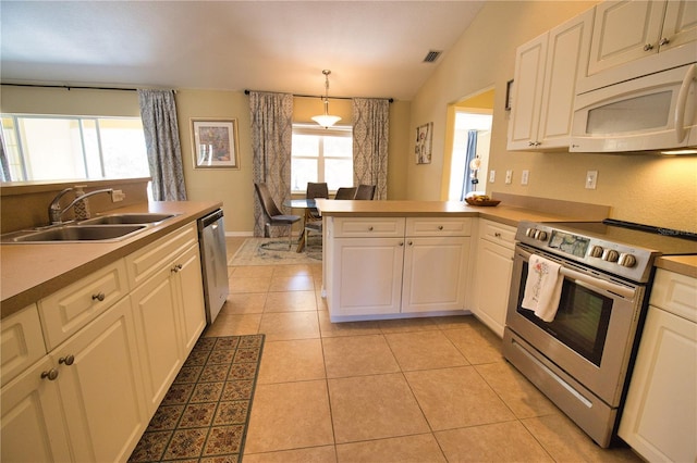 kitchen with visible vents, light tile patterned floors, appliances with stainless steel finishes, a peninsula, and a sink