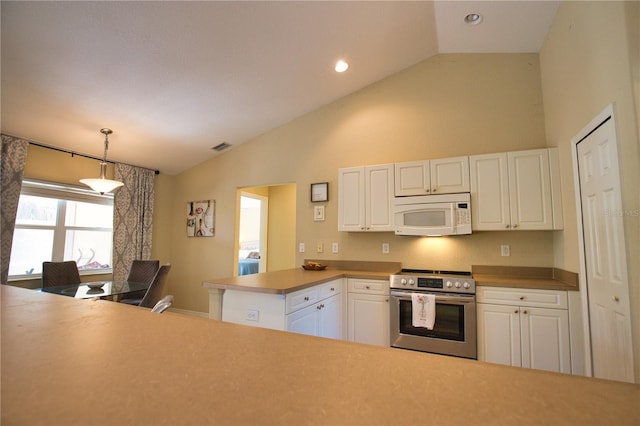 kitchen featuring white microwave, a peninsula, white cabinetry, and electric stove