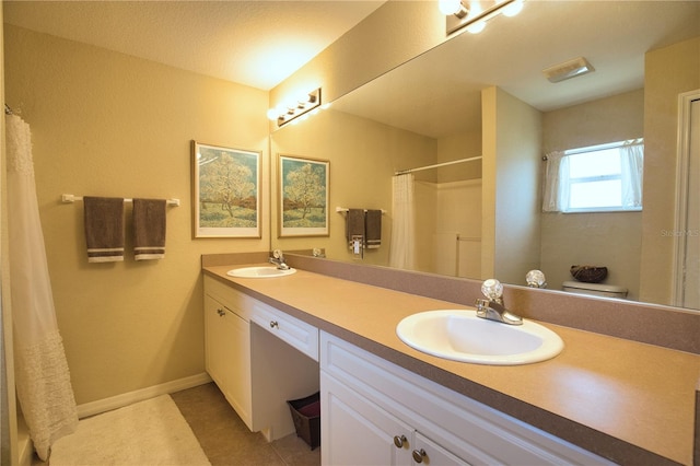 full bath featuring a shower with shower curtain, double vanity, baseboards, and a sink