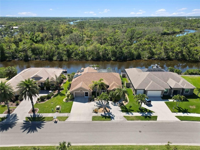 bird's eye view with a forest view and a water view