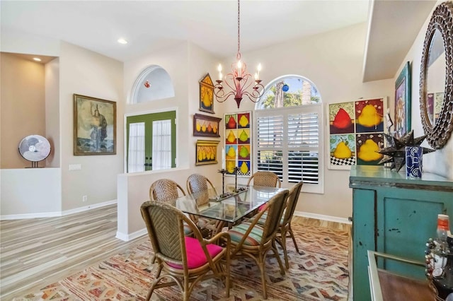 dining area with recessed lighting, baseboards, a notable chandelier, and wood finished floors