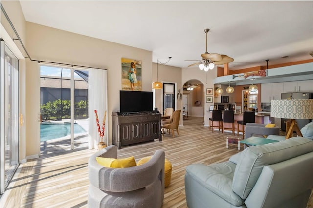 living room featuring light wood finished floors and a ceiling fan