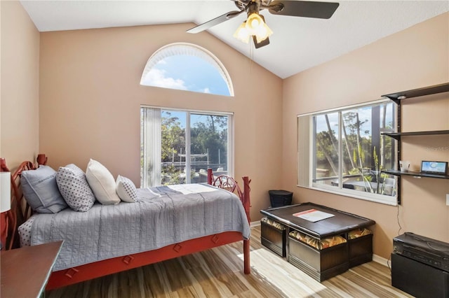 bedroom featuring baseboards, a ceiling fan, lofted ceiling, and wood finished floors