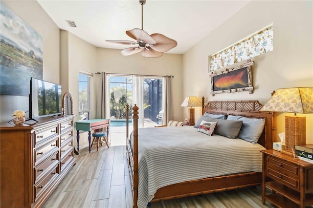 bedroom with access to exterior, light wood-style flooring, a ceiling fan, and visible vents