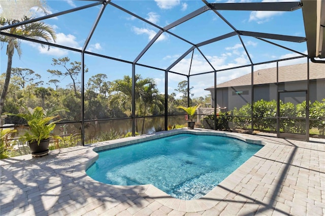 pool with glass enclosure and a patio area