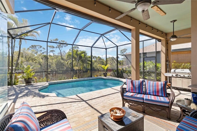 outdoor pool with a patio area, grilling area, glass enclosure, and an outdoor living space