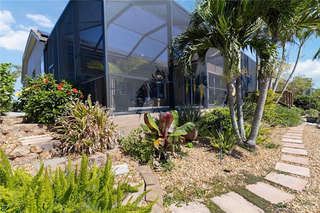 back of property featuring glass enclosure