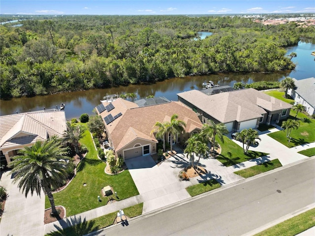 aerial view featuring a wooded view and a water view