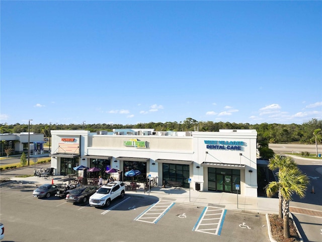 view of building exterior with uncovered parking