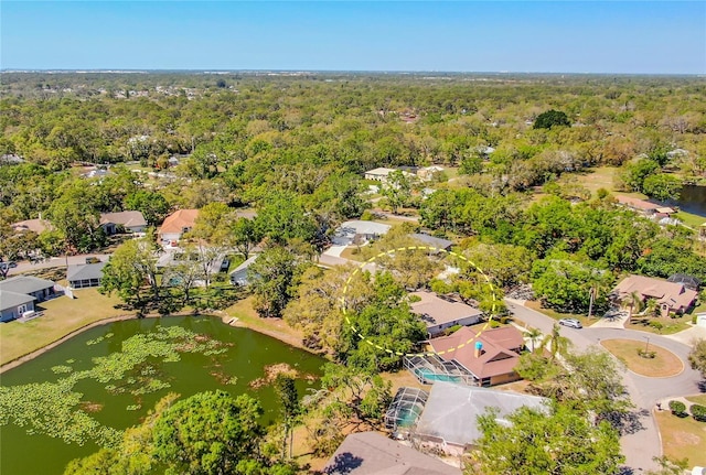 bird's eye view with a residential view, a wooded view, and a water view