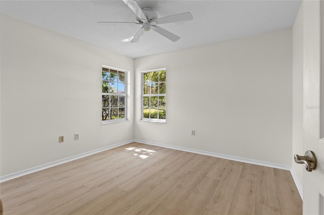 unfurnished room featuring a ceiling fan, baseboards, and light wood finished floors