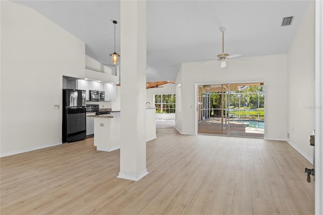 unfurnished living room featuring light wood finished floors, visible vents, high vaulted ceiling, and ceiling fan