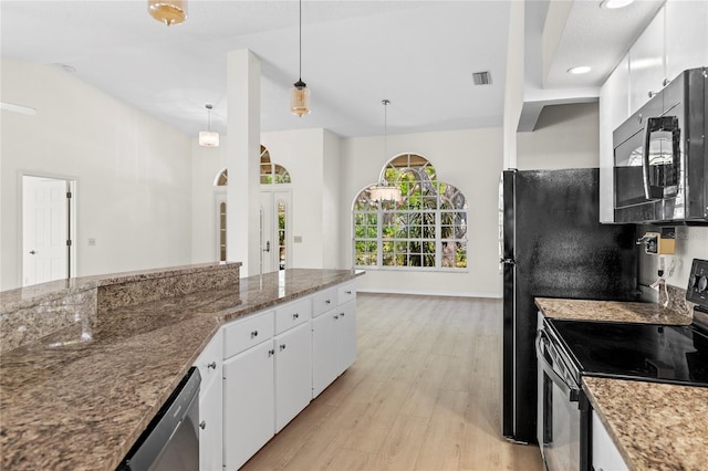 kitchen featuring visible vents, black appliances, stone counters, light wood-style floors, and white cabinetry