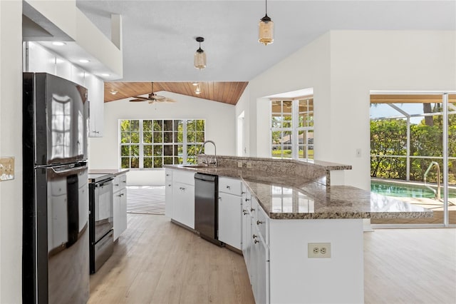 kitchen featuring a sink, lofted ceiling, black appliances, and white cabinets