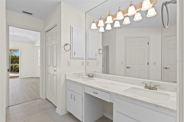 full bath featuring a sink, visible vents, baseboards, and double vanity