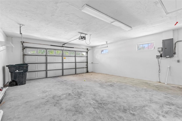 garage featuring electric panel and a garage door opener