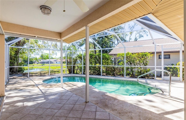 pool featuring glass enclosure and a patio area