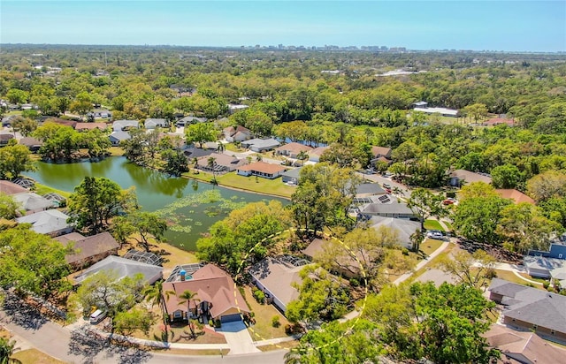 birds eye view of property with a residential view, a view of trees, and a water view