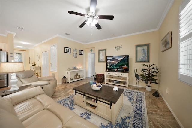 living room featuring crown molding, a ceiling fan, visible vents, and baseboards
