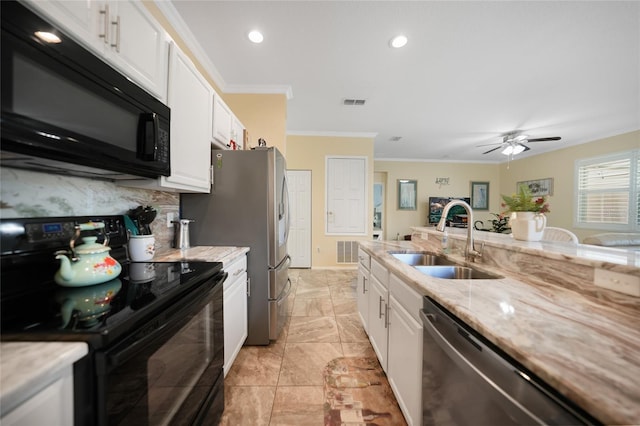 kitchen with a sink, visible vents, black appliances, and white cabinets