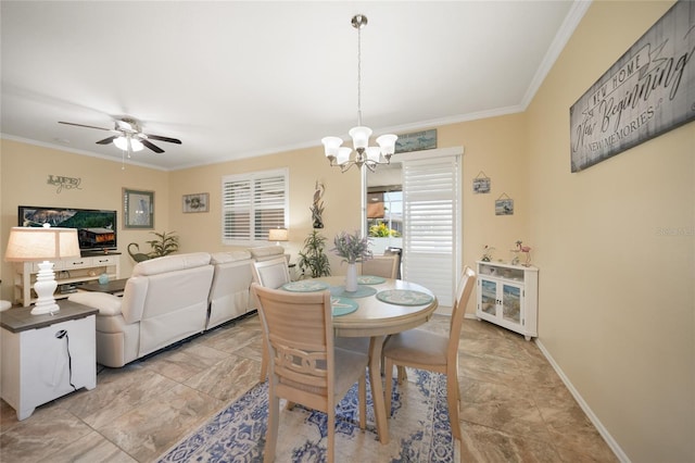 dining area with ceiling fan with notable chandelier, baseboards, and ornamental molding