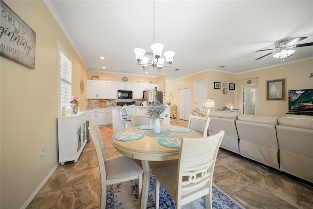 dining room featuring ceiling fan with notable chandelier, crown molding, and baseboards