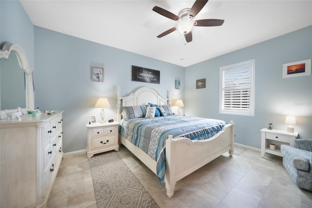 bedroom featuring baseboards, light tile patterned flooring, and a ceiling fan
