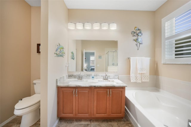full bath with a sink, toilet, a bath, and a shower stall