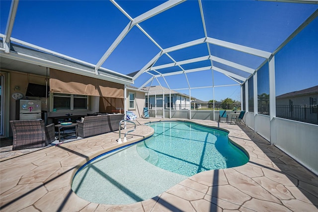 view of swimming pool with glass enclosure, a patio, a fenced in pool, and an outdoor living space