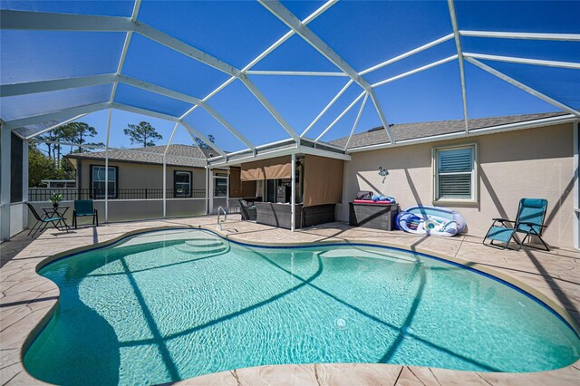 view of swimming pool featuring a fenced in pool, an outdoor hangout area, a lanai, and a patio area