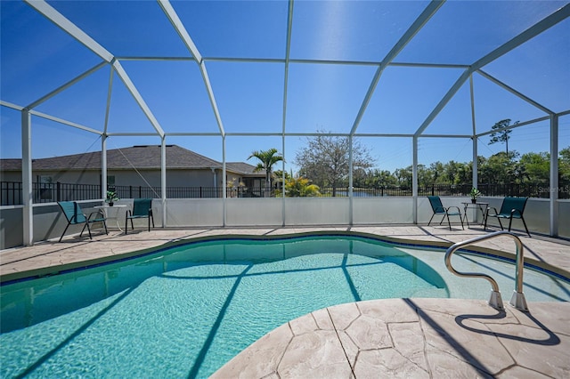 view of pool with a lanai, a fenced in pool, a patio, and fence