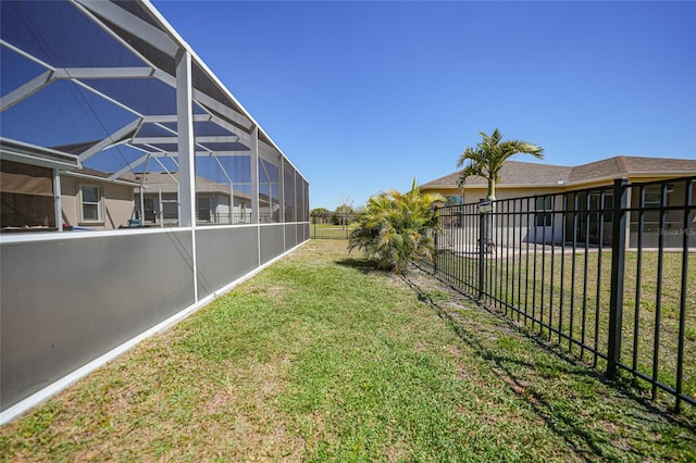 view of yard featuring glass enclosure and a fenced backyard