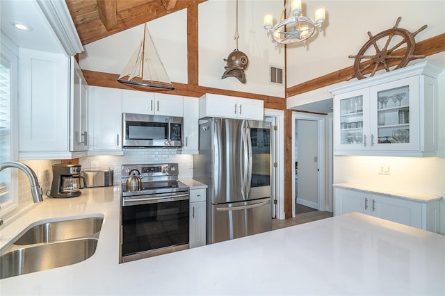 kitchen featuring visible vents, a sink, appliances with stainless steel finishes, light countertops, and decorative backsplash