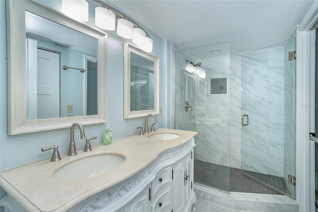 bathroom featuring a sink, double vanity, and a shower stall