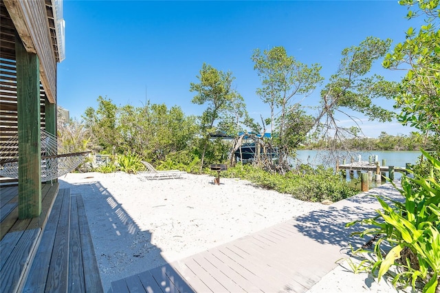 wooden terrace with a water view and a boat dock