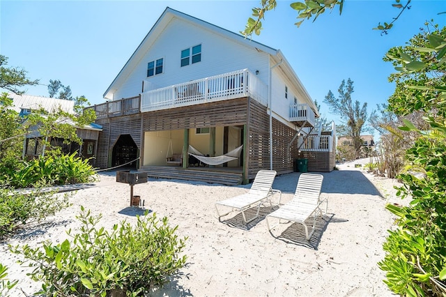 rear view of house featuring stairway and a patio