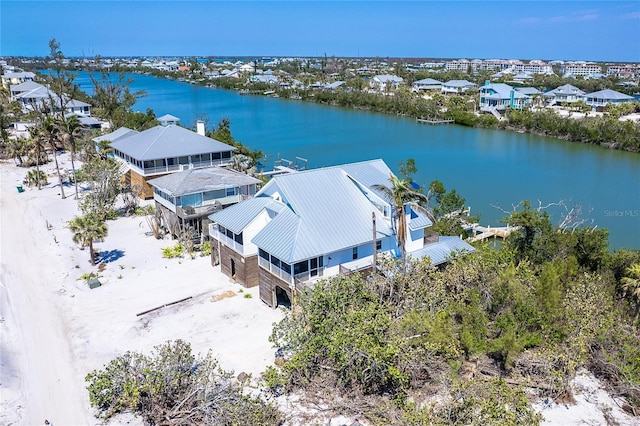 drone / aerial view with a residential view and a water view