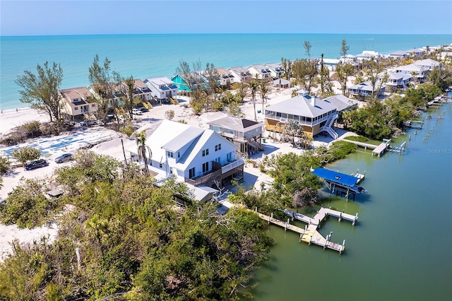 drone / aerial view with a residential view and a water view