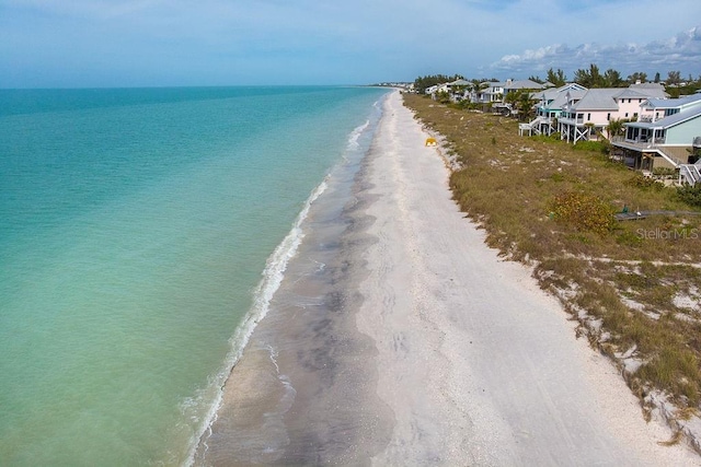 birds eye view of property featuring a view of the beach and a water view