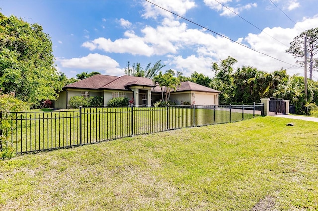 view of front of house featuring a front yard, a garage, and a fenced front yard